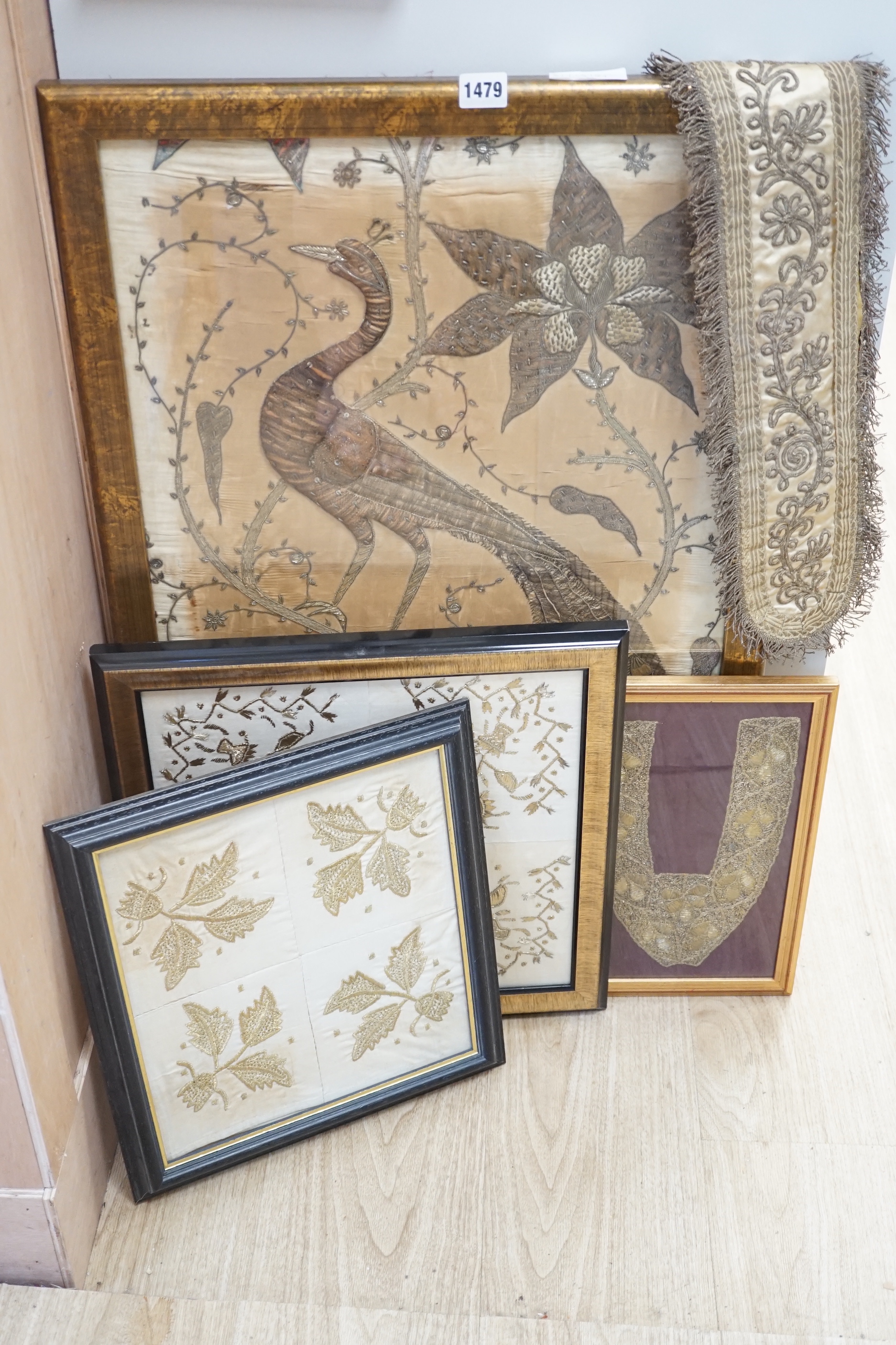 Three framed Indian gold thread embroideries and a similar tie back, largest 45cm x 74cm